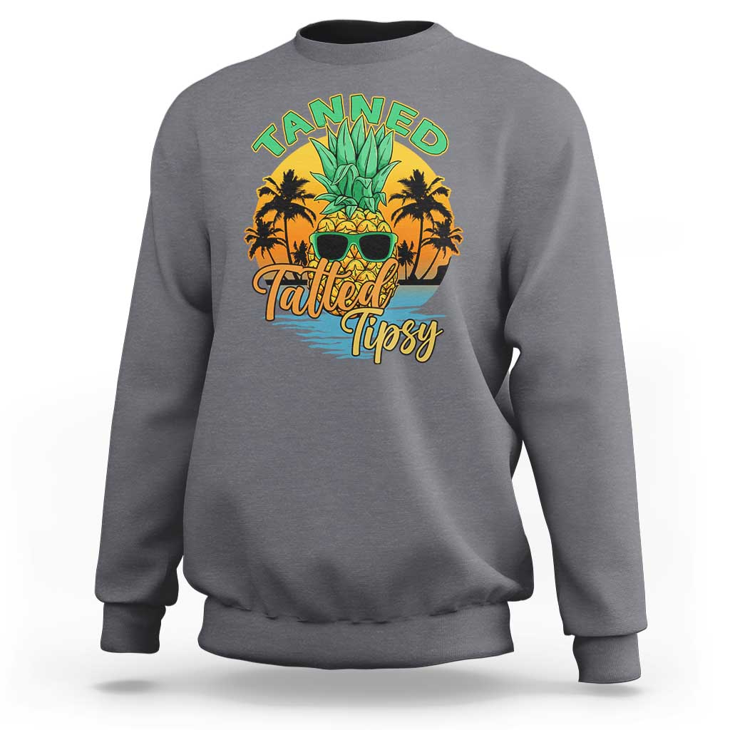 Charcoal crewneck sweatshirt with front 'Tanned Tatted Tipsy' pineapple tropical graphic