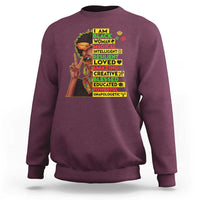 Maroon crewneck sweatshirt with colorful stacked “I AM BLACK” graphic on front