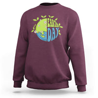 Maroon sweatshirt with Earth Day “Earth Day” graphic on the chest