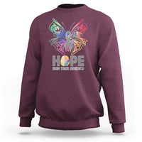 Maroon sweatshirt with colorful butterfly HOPE graphic and brain tumor awareness text
