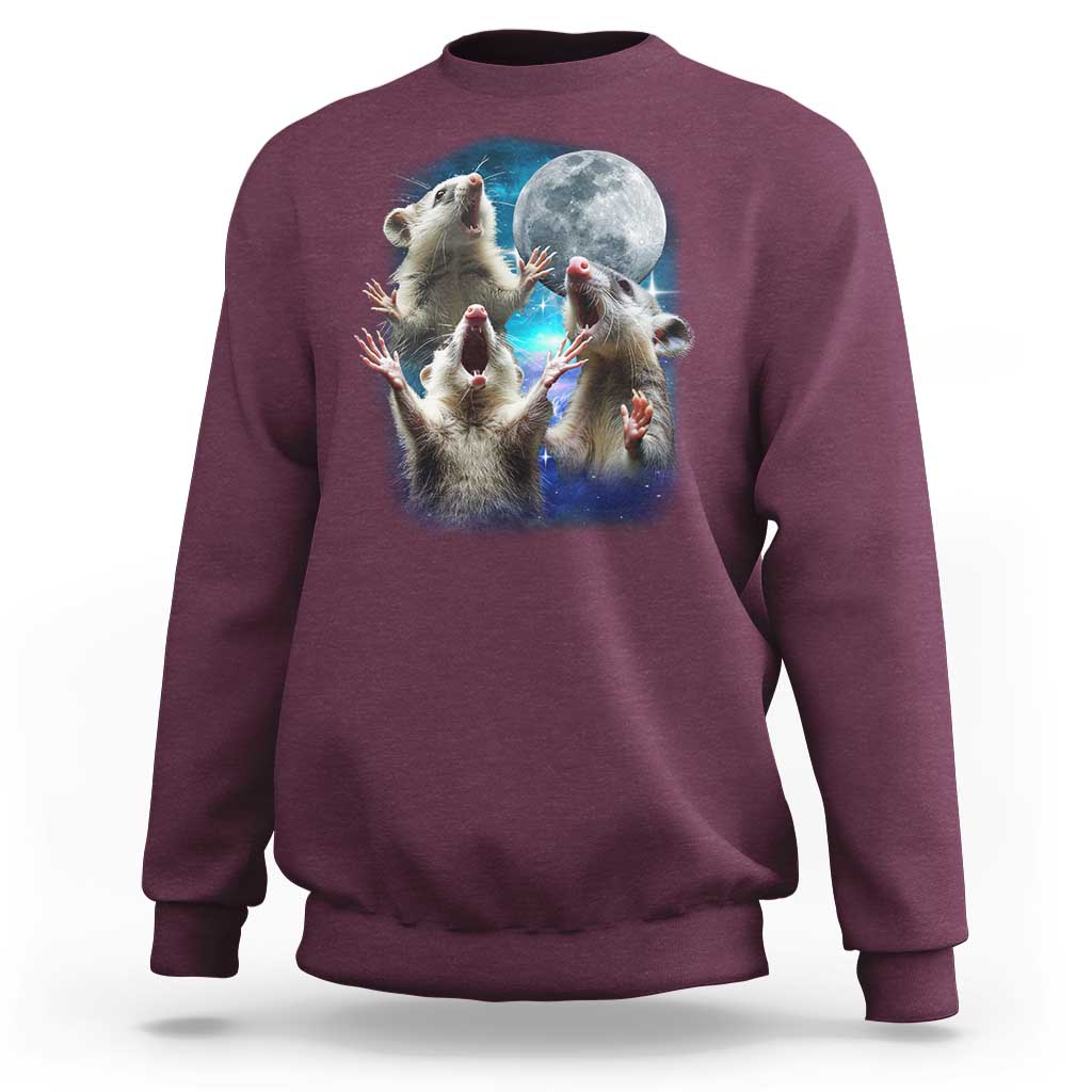 Maroon crewneck sweatshirt with three opossums under-moon graphic.