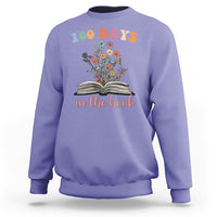 Violet crewneck sweatshirt with “100 Days” floral open-book “in the book” graphic