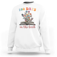 White crewneck sweatshirt with “100 Days” floral open-book “in the book” graphic