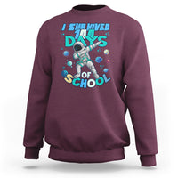 Maroon crewneck sweatshirt with astronaut dabbing graphic and school days print
