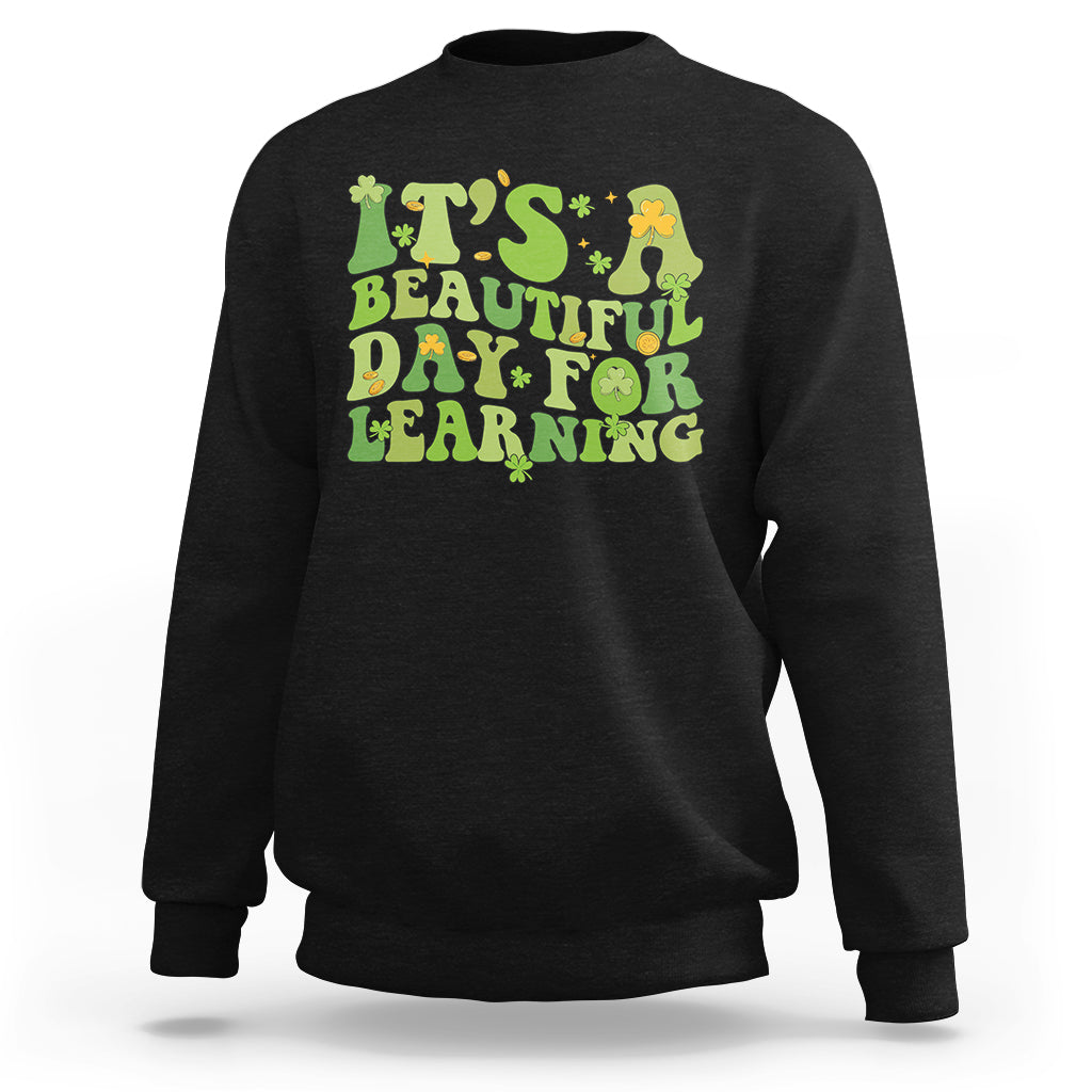 Black students sweatshirt with green and yellow text graphic: "It's Beautiful Day for Learning".