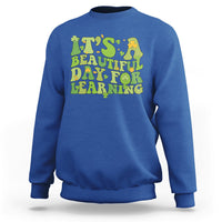 Royal blue students sweatshirt with green and yellow text graphic: "It's Beautiful Day for Learning".