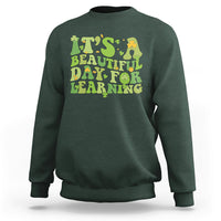 Forest green students sweatshirt with green and yellow text graphic: "It's Beautiful Day for Learning".