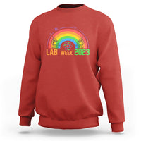 Crewneck lab sweatshirt in red with Lab Week 2023 rainbow graphic