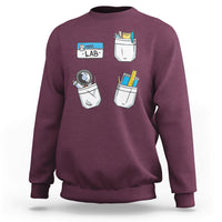 Maroon crewneck sweatshirt with lab tech graphic on front