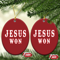 Two red oval ornaments with 'JESUS WON' text, each with a gold hanging cord.