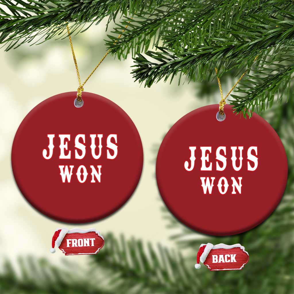 Set of two red round ornaments with 'JESUS WON' on front and back, gold hanging cords.