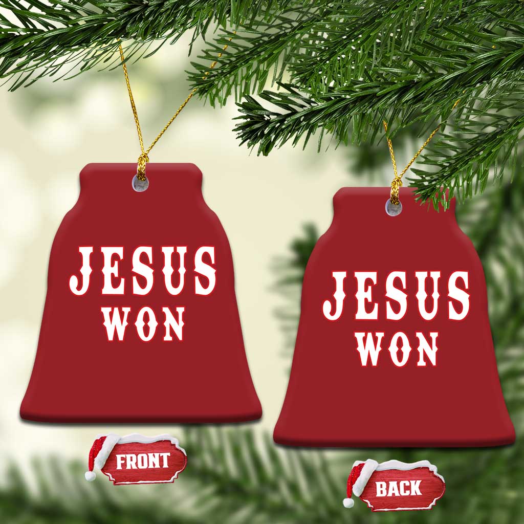 Red bell-shaped Christmas ornament with 'JESUS WON' text and a gold hanging loop.