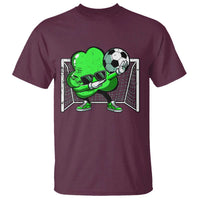 Maroon crew-neck T-shirt with green soccer player dabbing graphic behind goals