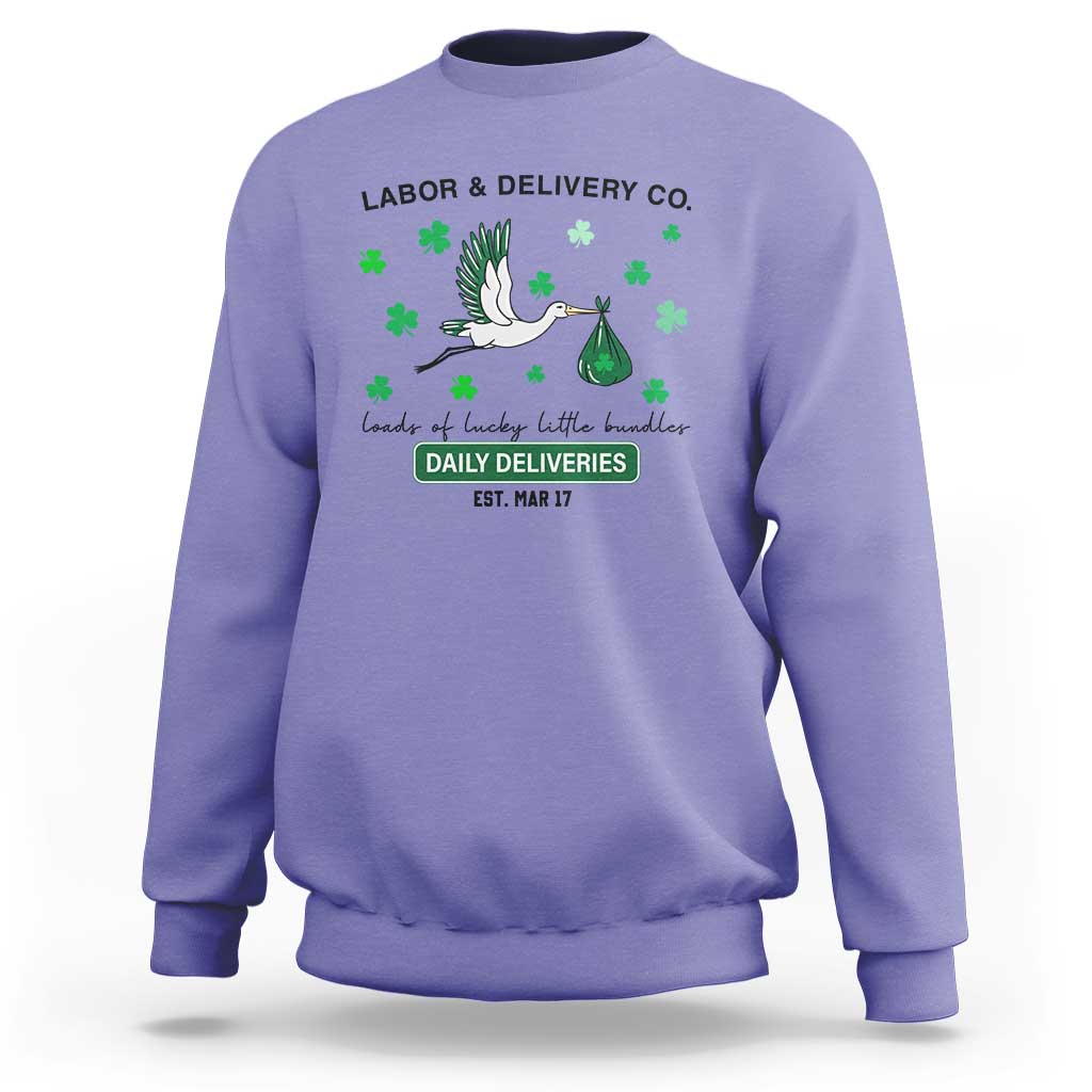 Purple nurse sweatshirt with green shamrock graphic and Labor & Delivery text