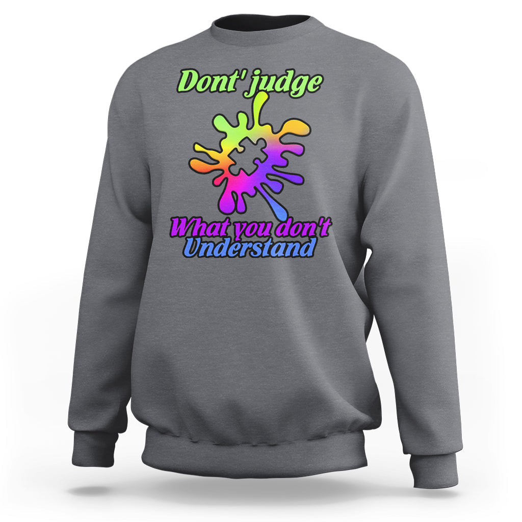 Charcoal gray sweatshirt with autism puzzle graphic: “Don't judge” and “What you don't Understand”
