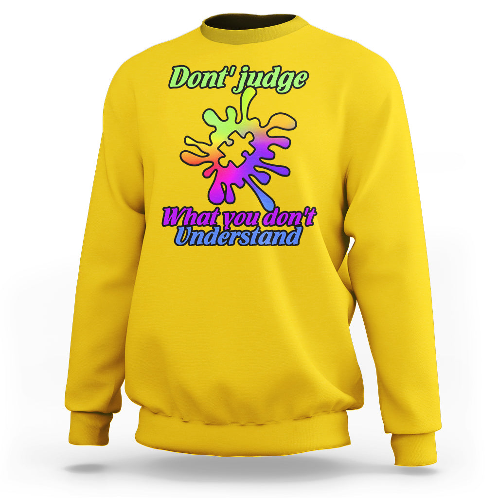 Daisy yellow sweatshirt with autism puzzle graphic: “Don't judge” and “What you don't Understand”