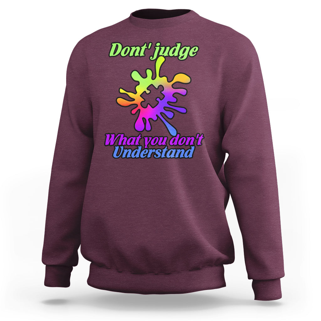 Maroon sweatshirt with autism puzzle graphic: “Don't judge” and “What you don't Understand”