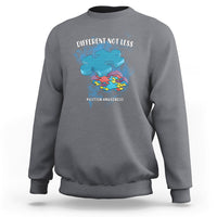Charcoal gray crewneck sweatshirt with “DIFFERENT NOT LESS” autism awareness graphic