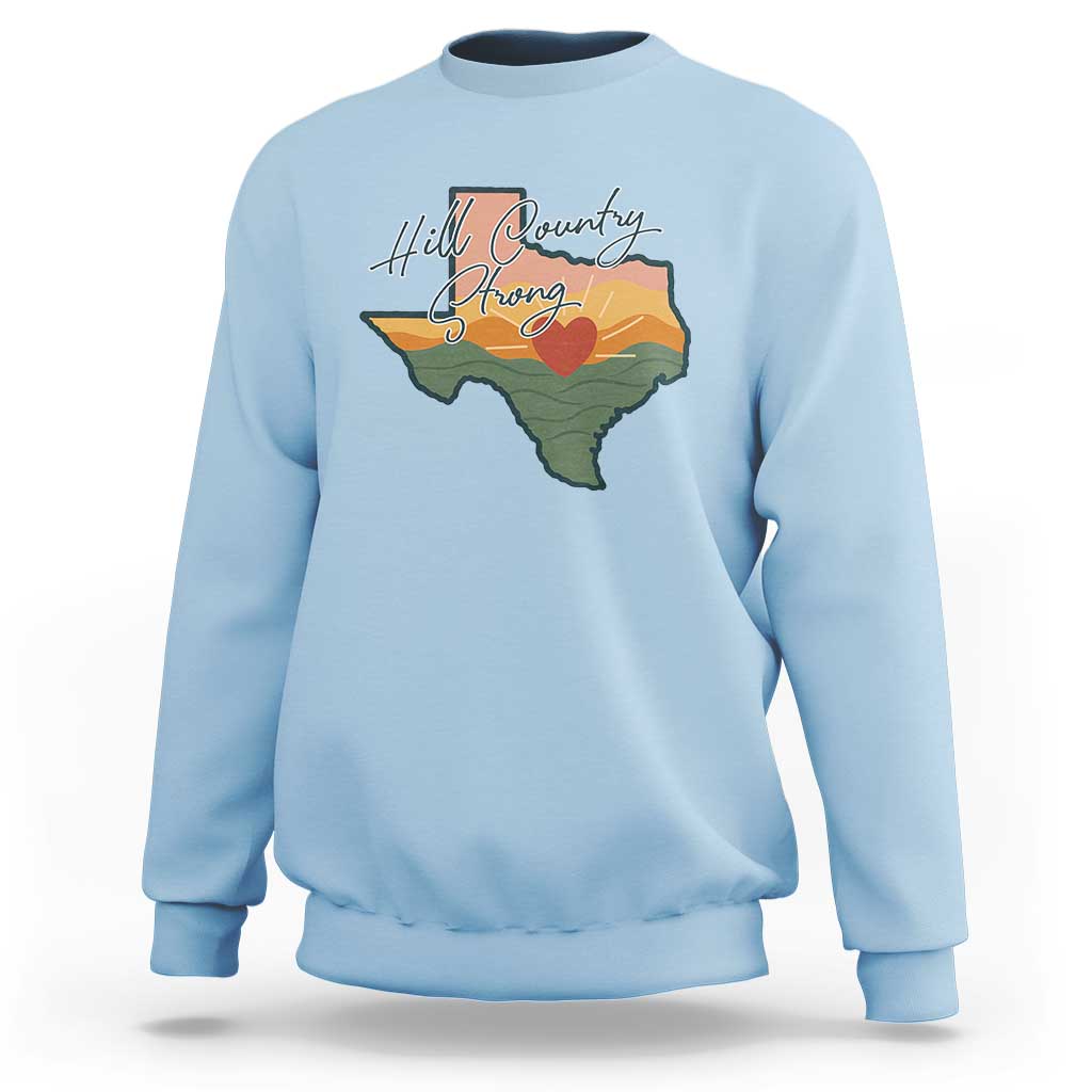 Light blue crewneck sweatshirt with Texas map graphic and “Hill Country Strong” text