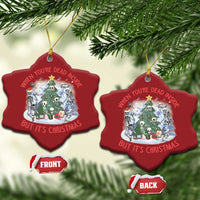 Two red heart-shaped Christmas ornaments hanging on tree branches