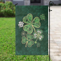 Irish green garden flag hanging on pole, featuring gold shamrock and clover artwork