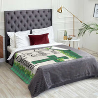 Green buffalo plaid shamrock throw blanket with cross motif on bed surface