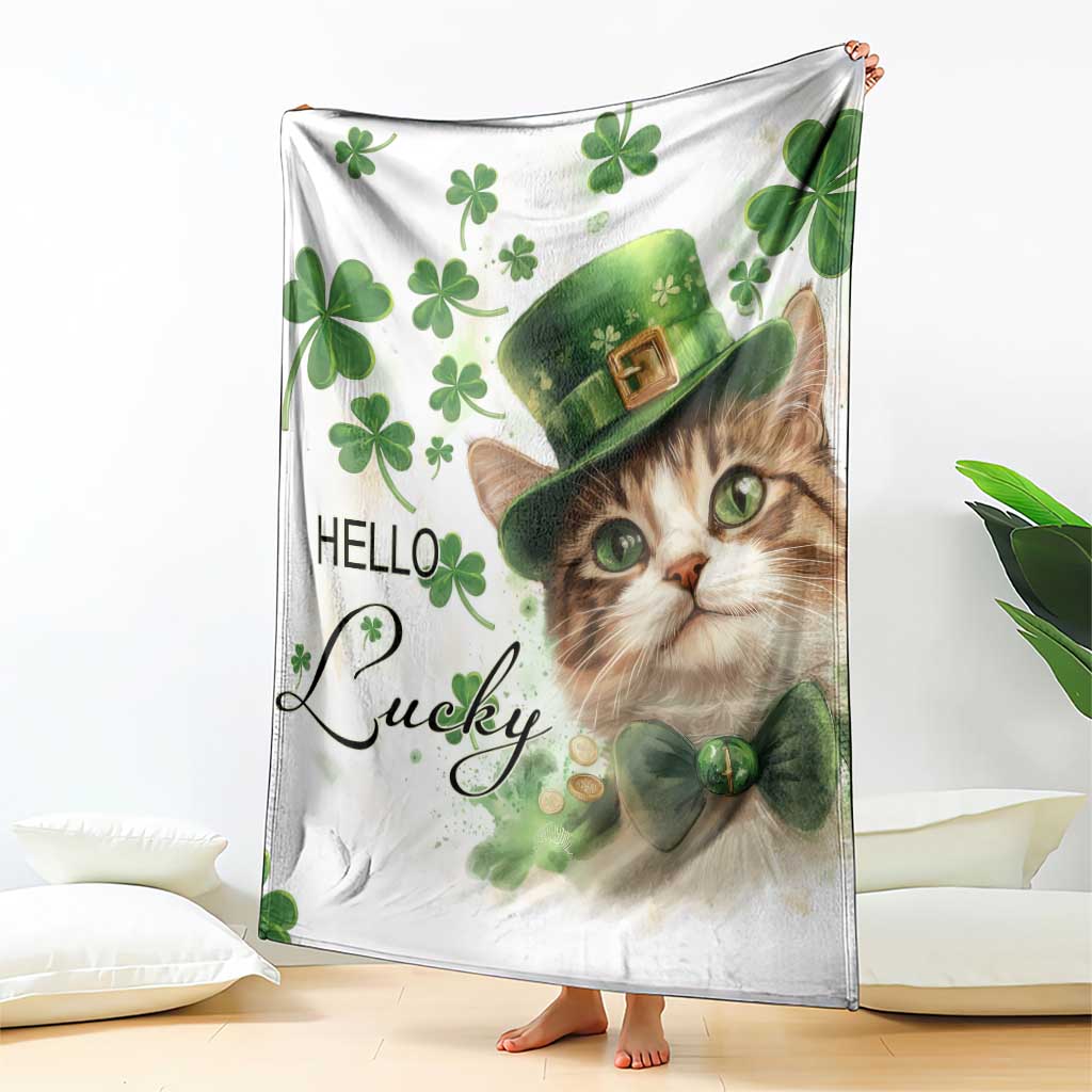 White cat throw blanket draped, featuring green clovers and leprechaun hat with “Hello Lucky”