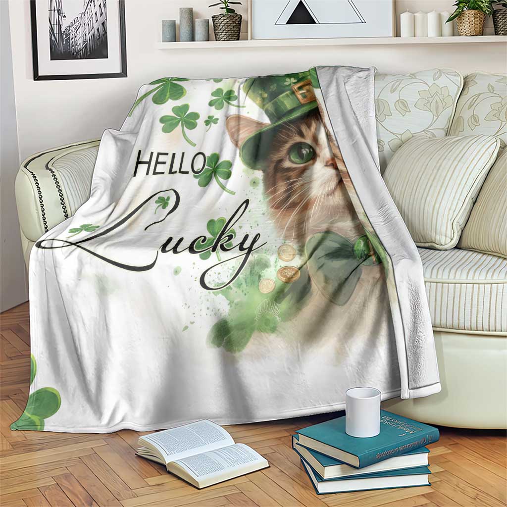 White throw blanket with cat face in green leprechaun hat and clovers, “Hello Lucky” print