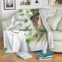 White throw blanket with cat face in green leprechaun hat and clovers, “Hello Lucky” print