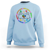 Light blue crewneck sweatshirt with colorful cat-face inclusion graphic