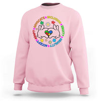 Light pink crewneck sweatshirt with colorful cat-face inclusion graphic