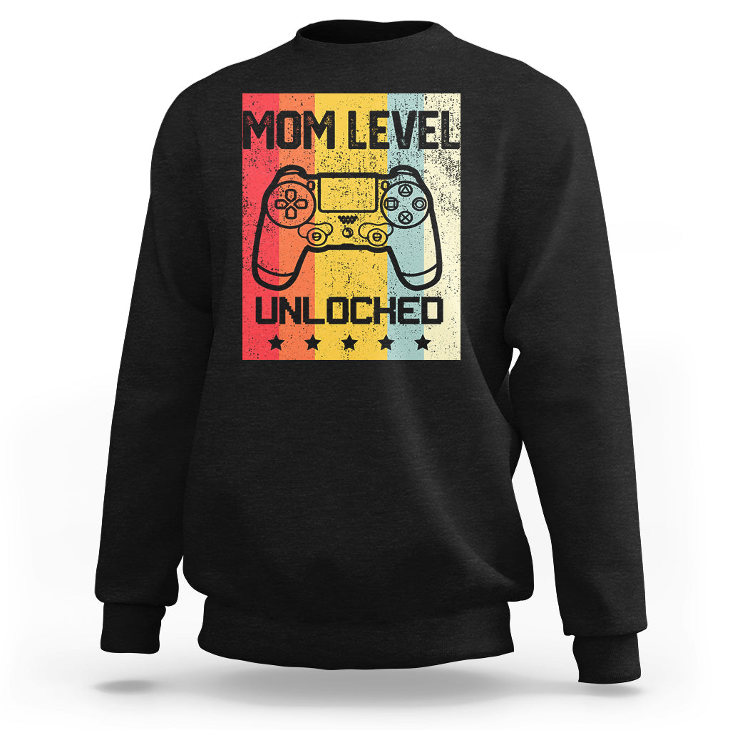 Black crewneck sweatshirt with “Mom Level Unlocked” gaming controller graphic