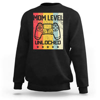 Black crewneck sweatshirt with “Mom Level Unlocked” gaming controller graphic