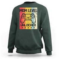 Dark forest green crewneck sweatshirt with “Mom Level Unlocked” gaming controller graphic