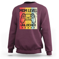 Maroon crewneck sweatshirt with “Mom Level Unlocked” gaming controller graphic