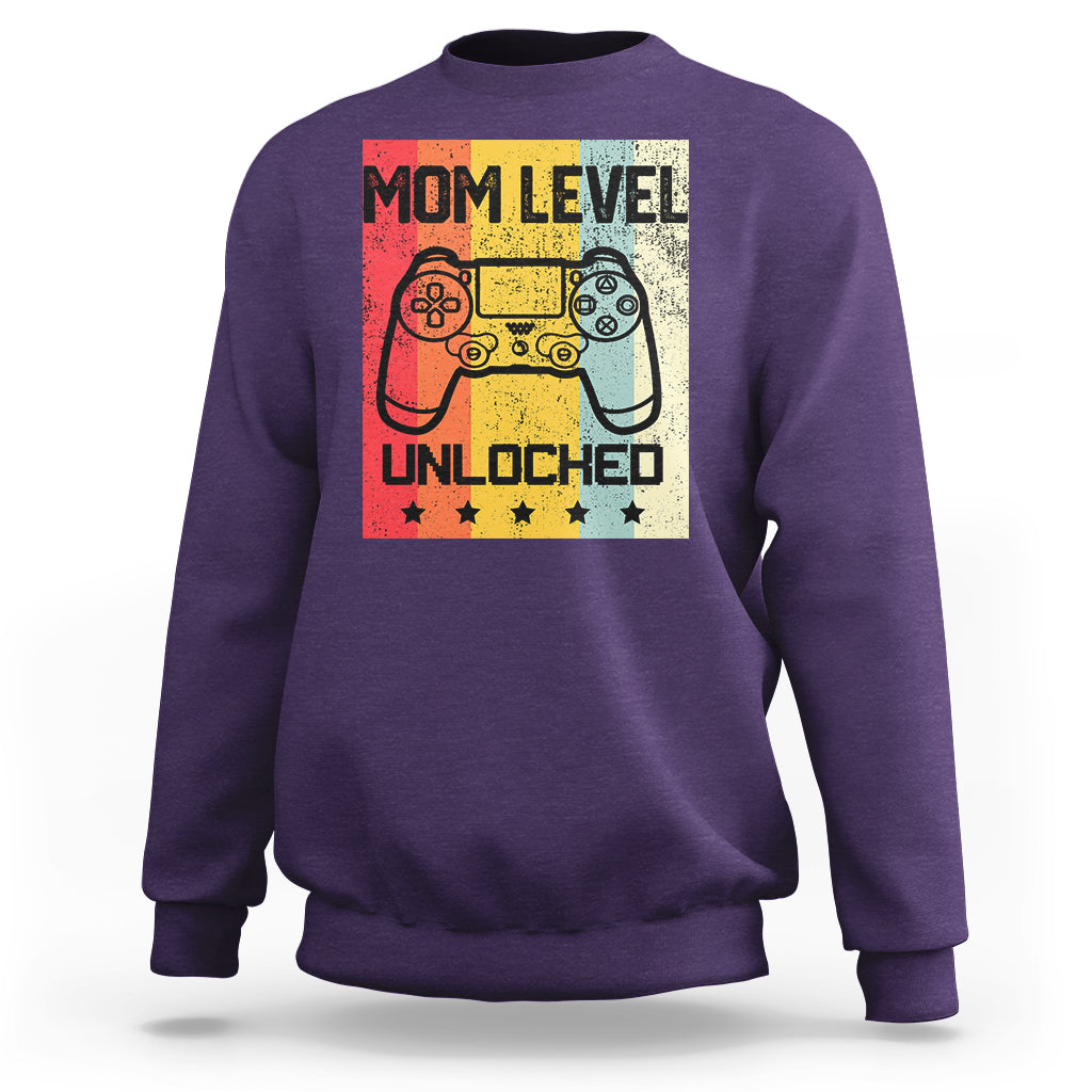 Purple crewneck sweatshirt with “Mom Level Unlocked” gaming controller graphic