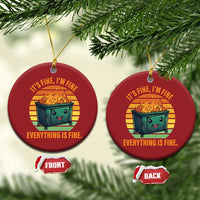 Two red round Christmas ornaments hanging from branches, each with burning dumpster graphic.