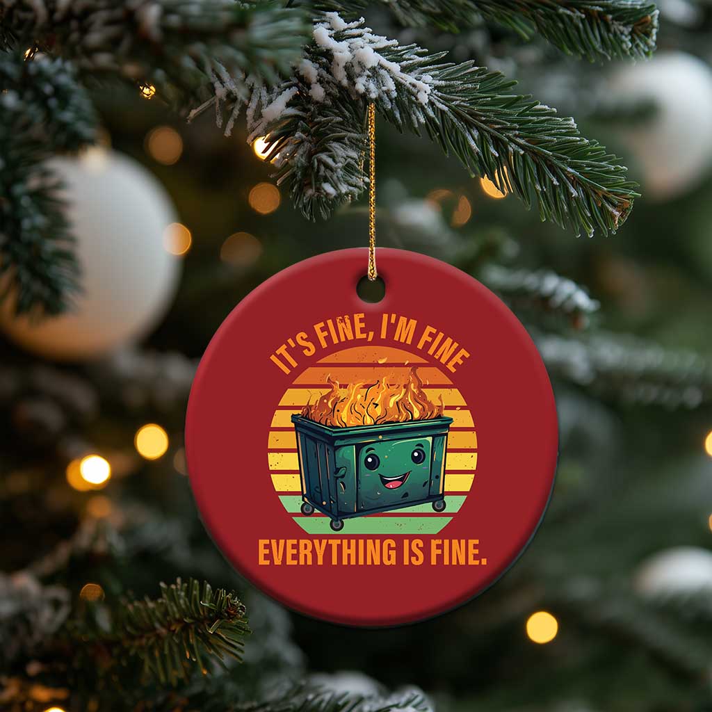 Red round Christmas ornament with smiling burning dumpster graphic and “Everything is Fine.”