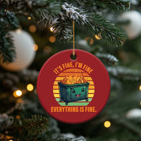 Red round Christmas ornament with smiling burning dumpster graphic and “Everything is Fine.”