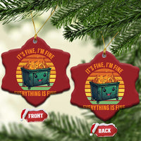 Two red heart-shaped Christmas ornaments hanging from pine branches with burning dumpster graphic.
