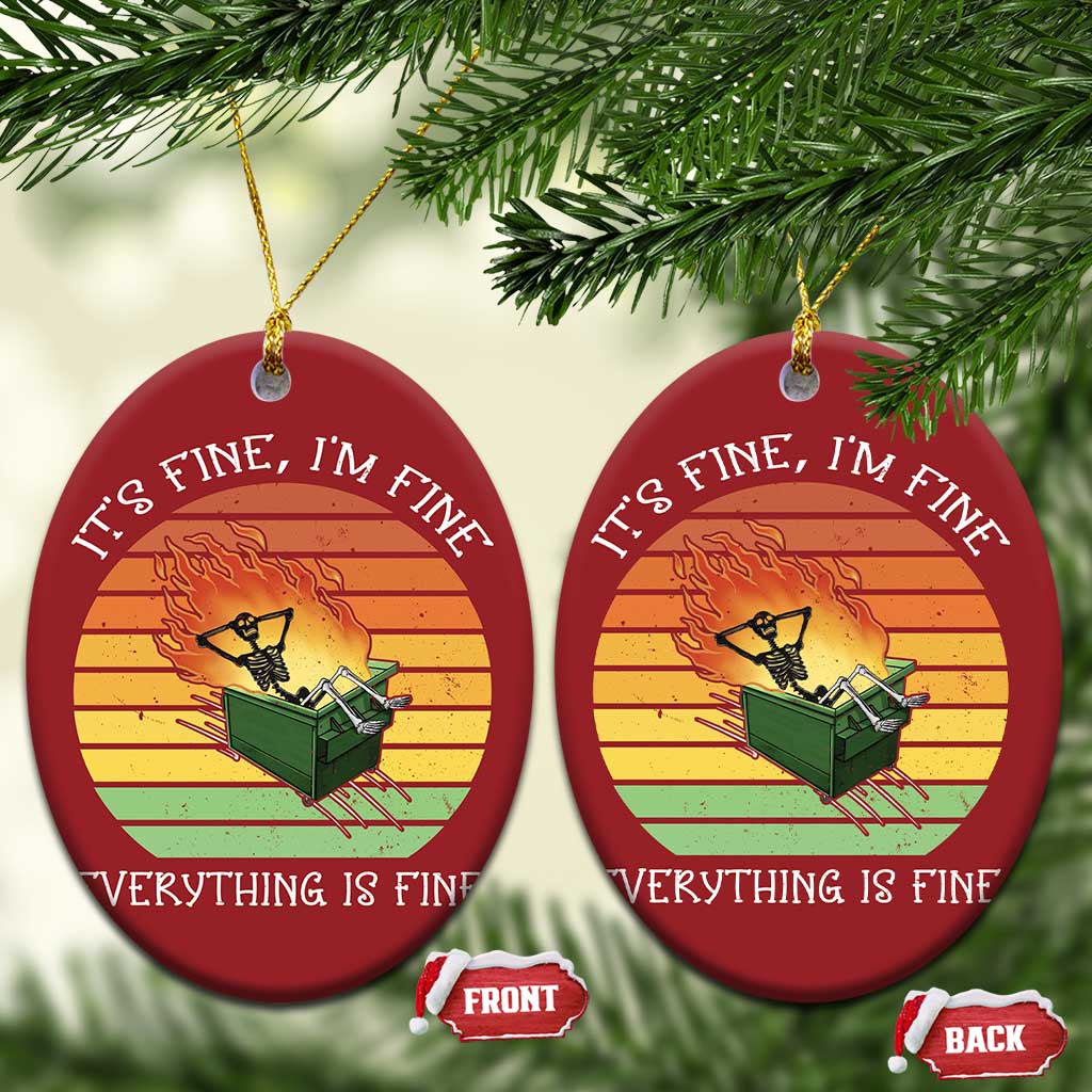 Two red oval Christmas ornaments with skeleton fire artwork and gold hanging strings