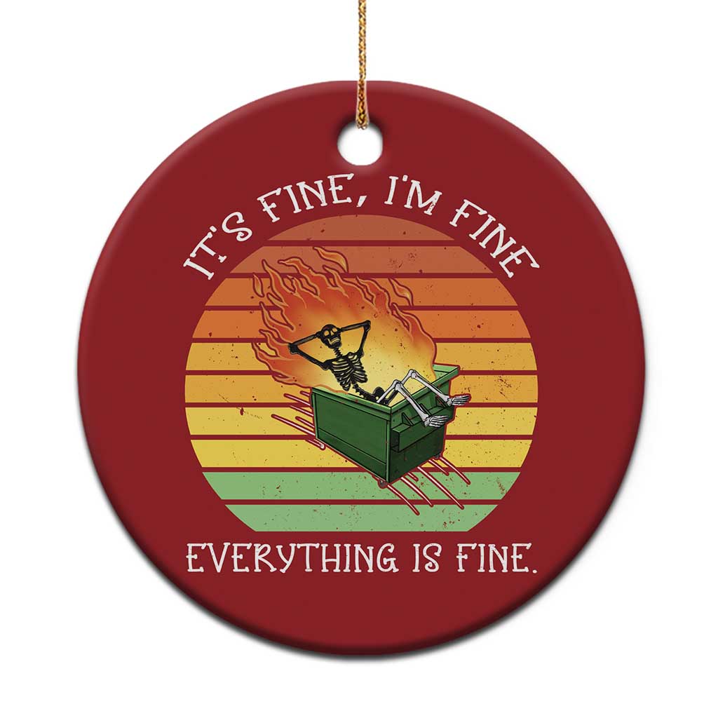 Red round Christmas ornament with skeleton fire graphic and gold hanging loop