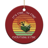 Red round Christmas ornament with skeleton fire graphic and gold hanging loop