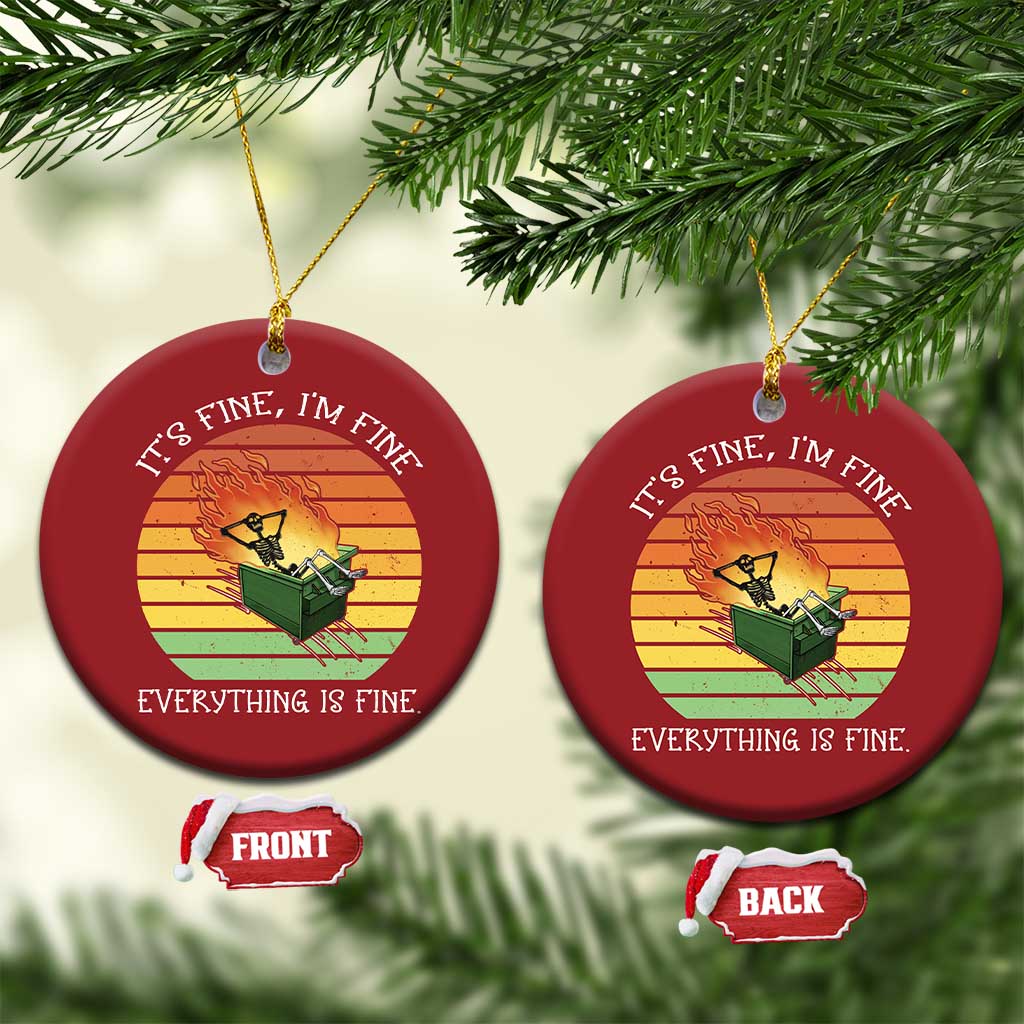 Set of two red round Christmas ornaments with skeleton fire graphic and gold hangers