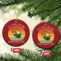 Set of two red round Christmas ornaments with skeleton fire graphic and gold hangers