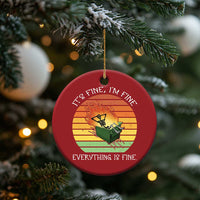 Red round Christmas ornament featuring skeleton fire artwork and gold hanging string