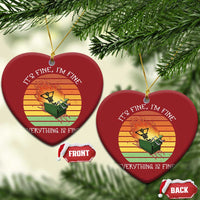 Pair of red heart Christmas ornaments with skeleton fire graphic and gold hanging loops