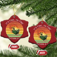 Two red heart Christmas ornaments with skeleton fire artwork and gold hanging loop