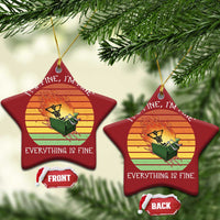 Two red star-shaped Christmas ornaments with skeleton fire graphic and gold hanging loops