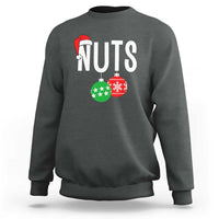 Dark heather crewneck sweatshirt with “NUTS” holiday nut graphic and red Santa hat